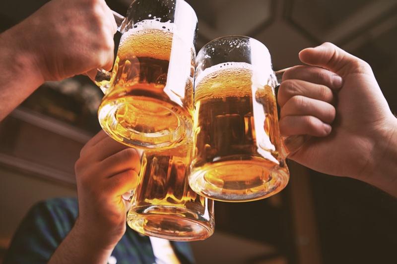 Friends toasting beers at Sibling Revelry Brewing